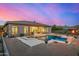 Enjoy this backyard oasis featuring a sparkling pool and spa, perfect for relaxation and entertaining, surrounded by desert landscape at 14523 E Charter Oak Dr, Scottsdale, AZ 85259