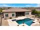 Relaxing backyard oasis featuring a sparkling pool, spa, and covered patio at 14523 E Charter Oak Dr, Scottsdale, AZ 85259