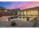 Inviting pool featuring desert landscaping, rock accents, and a covered patio at 14523 E Charter Oak Dr, Scottsdale, AZ 85259