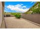 Gravel side yard with trees and a block wall provides privacy and separation at 14523 E Charter Oak Dr, Scottsdale, AZ 85259