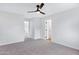 Neutral bedroom with gray carpet and modern ceiling fan at 1563 S Longspur Ln, Gilbert, AZ 85296