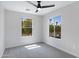 Bedroom featuring two windows with bright light and neutral gray carpeting at 1563 S Longspur Ln, Gilbert, AZ 85296