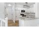 Bright white kitchen with granite countertops, stainless steel appliances, and modern lighting fixture at 1563 S Longspur Ln, Gilbert, AZ 85296