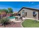 Stunning backyard showcasing a private pool, lush landscaping, and a covered patio adjacent to the home at 15743 N 165Th Ln, Surprise, AZ 85388