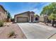 Charming single-story home featuring a well-maintained yard, desert landscaping and an attached two-car garage at 15743 N 165Th Ln, Surprise, AZ 85388
