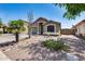 Charming single-story home featuring a well-maintained yard, desert landscaping and an attached two-car garage at 15743 N 165Th Ln, Surprise, AZ 85388