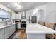 Well-lit kitchen with stainless steel appliances, white countertops, and modern lighting fixtures at 15743 N 165Th Ln, Surprise, AZ 85388