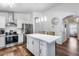 Bright kitchen featuring white cabinets, stainless steel appliances, pendant lighting, and an island with seating at 15743 N 165Th Ln, Surprise, AZ 85388