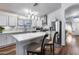 Bright kitchen featuring white cabinets, stainless steel appliances, pendant lighting, and an island with seating at 15743 N 165Th Ln, Surprise, AZ 85388