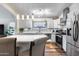 Bright kitchen featuring white cabinets, stainless steel appliances, and an island with seating at 15743 N 165Th Ln, Surprise, AZ 85388