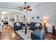 Inviting living room featuring hardwood floors, ceiling fan, and modern furnishings near kitchen at 15743 N 165Th Ln, Surprise, AZ 85388