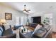 Comfortable living room with a vaulted ceiling, entertainment center, and access to the outdoors at 15743 N 165Th Ln, Surprise, AZ 85388