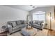 Inviting living room with vaulted ceiling, wood floors and neutral decor provides a relaxing atmosphere at 15743 N 165Th Ln, Surprise, AZ 85388