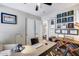 This office features an attached bathroom, a ceiling fan, luxury vinyl plank flooring, and custom built-in shelving at 15743 N 165Th Ln, Surprise, AZ 85388