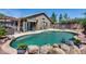 Beautiful backyard featuring a private in-ground pool, patio area, and mature landscaping at 15743 N 165Th Ln, Surprise, AZ 85388