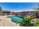 Beautiful pool with a rock waterfall feature and mature landscaping creating a private backyard oasis at 15743 N 165Th Ln, Surprise, AZ 85388