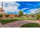 Spacious backyard with lush green grass, mature trees, beautiful landscaping and rock walkway at 16017 S 12Th Pl, Phoenix, AZ 85048