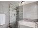 Modern bathroom showcasing a glass-enclosed shower, soaking tub, stylish fixtures, and a granite vanity at 16017 S 12Th Pl, Phoenix, AZ 85048