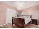 Cozy bedroom with wood-look floors, ceiling fan, closet, and access to the patio at 16017 S 12Th Pl, Phoenix, AZ 85048