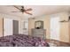 Bright bedroom with a ceiling fan, dresser, and ensuite bath access through a single door at 16017 S 12Th Pl, Phoenix, AZ 85048