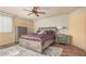Spacious bedroom features a ceiling fan, neutral decor, and a large bed with decorative pillows at 16017 S 12Th Pl, Phoenix, AZ 85048