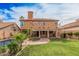 Lovely two-story home with a lush green backyard, covered patio, and a spiral staircase at 16017 S 12Th Pl, Phoenix, AZ 85048