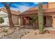 View of the house entrance with desert landscaping and a decorative cactus in the front yard at 16017 S 12Th Pl, Phoenix, AZ 85048