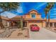 Charming two-story home with a tile roof, desert landscaping, and a red car parked in the driveway at 16017 S 12Th Pl, Phoenix, AZ 85048
