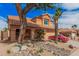 Charming two-story home featuring desert landscaping, a red car, and a covered front porch area at 16017 S 12Th Pl, Phoenix, AZ 85048