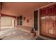 Covered front porch area featuring textured walls, a window, and a view to the side yard at 16017 S 12Th Pl, Phoenix, AZ 85048