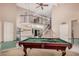 Bright game room featuring a billiard table, a high ceiling, and an open view to other living spaces at 16017 S 12Th Pl, Phoenix, AZ 85048