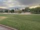 Scenic golf course view featuring lush green grass, desert landscaping, and homes in the background at 16017 S 12Th Pl, Phoenix, AZ 85048