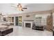 Open-concept living space featuring tile flooring, a fireplace, and sliding glass doors to the backyard at 16017 S 12Th Pl, Phoenix, AZ 85048