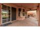 Spacious covered patio with ceiling fan, hanging chair, outdoor seating, and spiral staircase at 16017 S 12Th Pl, Phoenix, AZ 85048