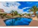 Sparkling pool surrounded by lush landscaping, lounge chairs, and palm trees, perfect for outdoor relaxation at 16017 S 12Th Pl, Phoenix, AZ 85048