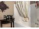 Bright bathroom featuring a bathtub with a patterned shower curtain and a decorative side table at 16626 E Westby Dr # 108, Fountain Hills, AZ 85268