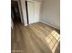 An empty bedroom featuring vinyl floors and a sliding closet at 170 E Guadalupe Rd # 173, Gilbert, AZ 85234