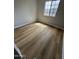 An empty bedroom with wood floors and a large window for natural light at 170 E Guadalupe Rd # 173, Gilbert, AZ 85234