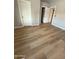 Bedroom features wood-look flooring, closet and entry door, and neutral paint at 170 E Guadalupe Rd # 173, Gilbert, AZ 85234