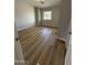 Bedroom with wood-look flooring, baseboards, and window for natural light at 170 E Guadalupe Rd # 173, Gilbert, AZ 85234