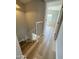 Hallway with wood floors, neutral paint, and staircase access at 170 E Guadalupe Rd # 173, Gilbert, AZ 85234
