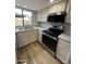 Updated kitchen features stainless steel appliances, granite countertops, and wood floors at 170 E Guadalupe Rd # 173, Gilbert, AZ 85234