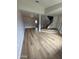Spacious living room featuring modern flooring and seamless transition to the staircase at 170 E Guadalupe Rd # 173, Gilbert, AZ 85234