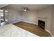 Cozy living room featuring wood flooring, granite counters, a ceiling fan, and a fireplace at 170 E Guadalupe Rd # 173, Gilbert, AZ 85234