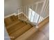 A staircase with modern wood stairs and a white railing leads to the next level at 170 E Guadalupe Rd # 173, Gilbert, AZ 85234