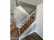 Staircase featuring wood steps and white railings at 170 E Guadalupe Rd # 173, Gilbert, AZ 85234