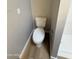 Toilet in bathroom features neutral paint and updated baseboards at 170 E Guadalupe Rd # 173, Gilbert, AZ 85234