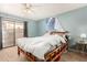 Bedroom with sliding glass door to outdoor balcony and ceiling fan at 1715 S Cholla St, Mesa, AZ 85202