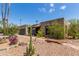 Southwest home with desert landscaping featuring rocks, cacti, and small bridge at 1715 S Cholla St, Mesa, AZ 85202