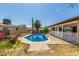 Kidney shaped pool with surrounding concrete and partial fence at 1715 S Cholla St, Mesa, AZ 85202